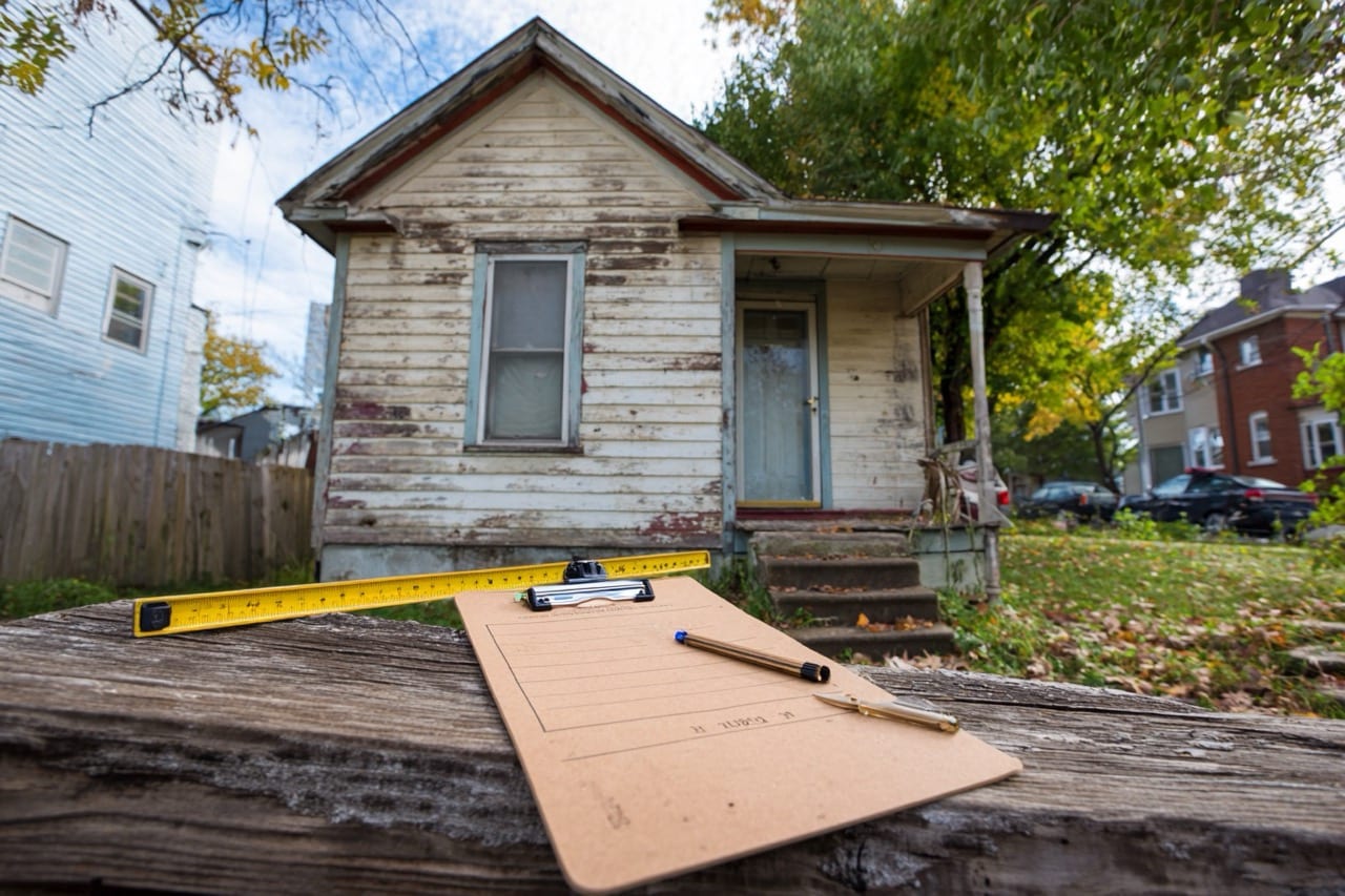 Property inspector examining storm damage on Kansas City MO home